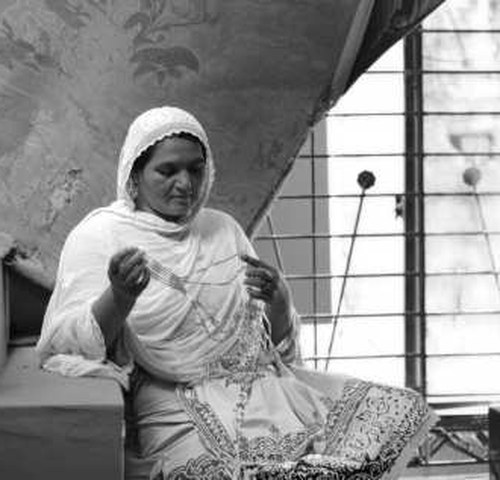 A woman working on embroidery — Kashf Foundation Impact Assessment Study 2025